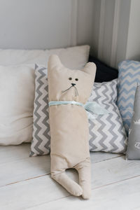 Baby pillow in the form of a cat on the bed in the child's room