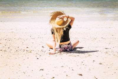 Woman with umbrella on beach