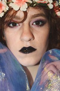 Close-up portrait of beautiful woman wearing flowers