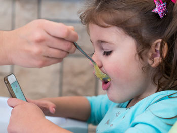 Close-up of girl eating food