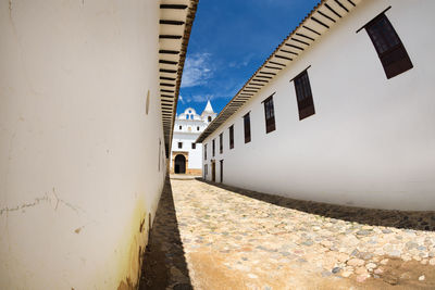 Alley amidst buildings against sky