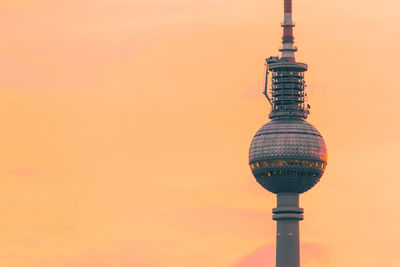 Low angle view of fernsehturm against sky during sunset