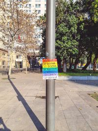Information sign on street by building in city