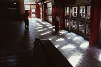 Full length of woman walking on tiled floor