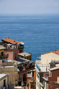 High angle view of townscape by sea against sky