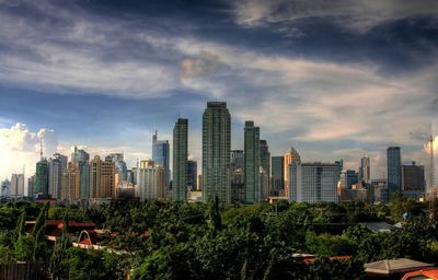 Skyscrapers against cloudy sky