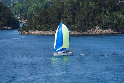 Boat sailing in sea against sky