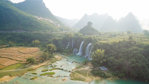 Scenic view of river flowing through mountains