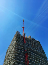 Low angle view of crane on building at construction site 
