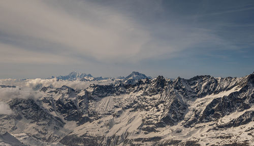 Scenic view of snowcapped mountains against sky during sunset