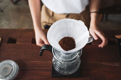 Midsection of man holding coffee cup