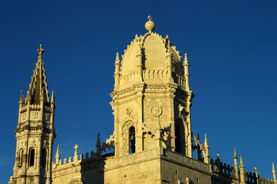 Low angle view of historical building against blue sky