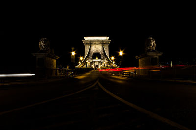 Illuminated tunnel at night