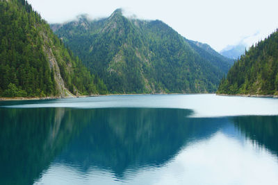 Scenic view of lake and mountains against sky