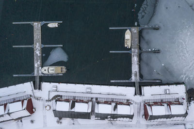 Directly above shot of houses by harbor during winter