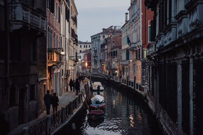 Panoramic view of canal amidst city against sky