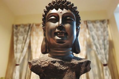 Close-up of buddha statue against temple