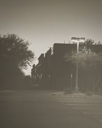 Empty road with buildings in background