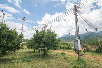 Overhead cable car on field against sky