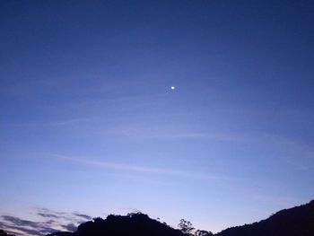 Scenic view of mountains against blue sky