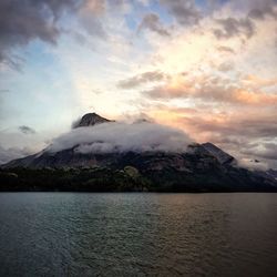 Scenic view of sea and mountains against sky