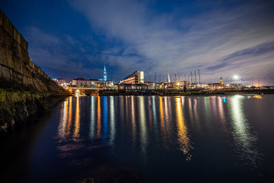 Illuminated city at waterfront