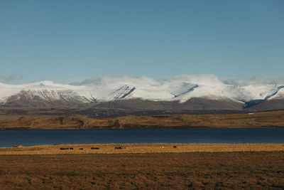 Scenic view of snowcapped mountains against clear sky