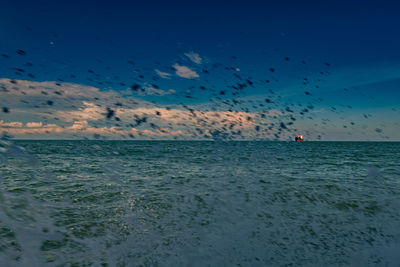 Scenic view of sea against blue sky