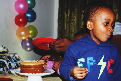 Boy looking away during birthday celebration at home