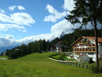 Houses on field against sky