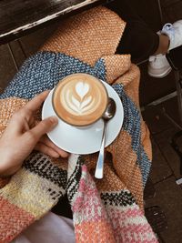 Midsection of woman holding coffee cup