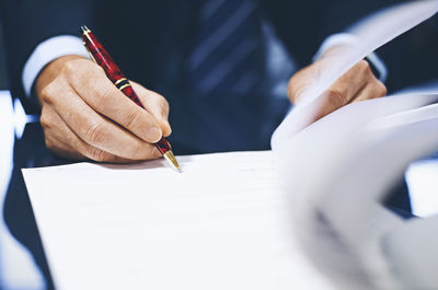 Close-up of human hand holding paper