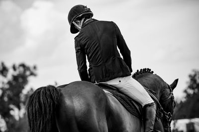 View of people riding horse against sky