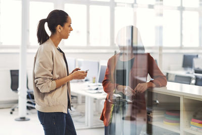 Two businesswomen discussing in office