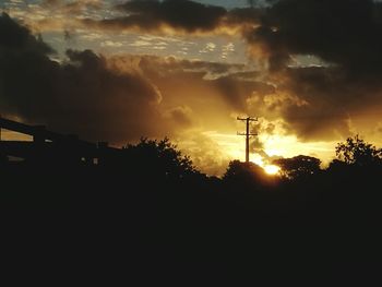 Low angle view of silhouette trees against sky during sunset