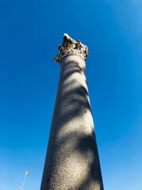 Low angle view of column against blue sky