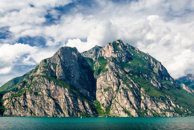 Scenic view of sea and mountains against sky