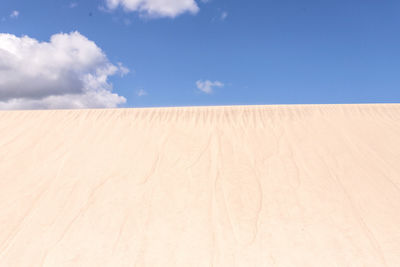 Scenic view of desert against blue sky