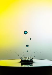 Close-up of water drop against blue background