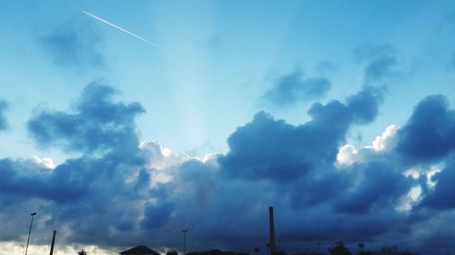 Low angle view of vapor trails in sky