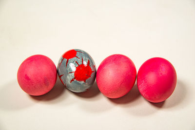 Close-up of red berries over white background