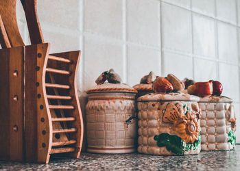 Close-up of lizard in basket on table against wall