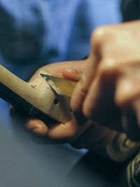 Luthier working a classic violin scroll