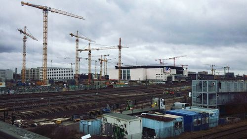 Construction site in city against sky