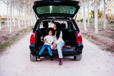 Rear view of people sitting in car