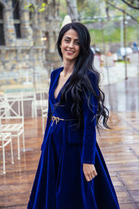 Portrait of a smiling young woman standing outdoors