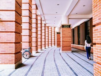 Rear view of woman walking in university