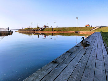 Pier over lake against sky