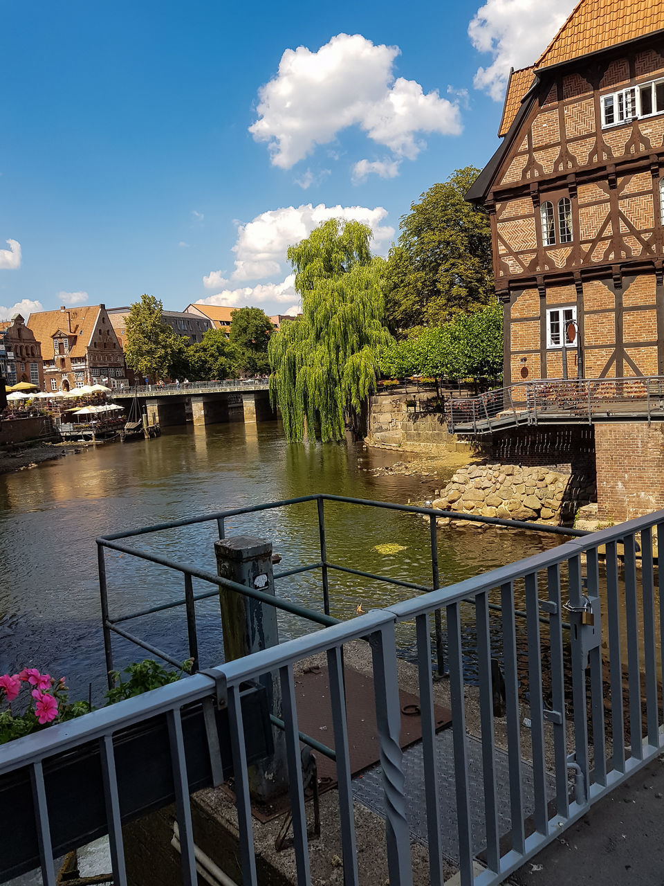 BRIDGE OVER RIVER AGAINST BUILDINGS IN CITY