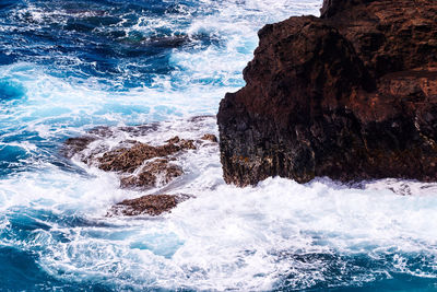 Waves splashing on rocks at shore